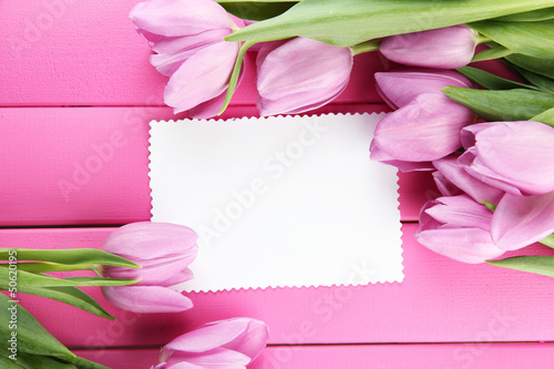 Beautiful bouquet of purple tulips and blank card © Africa Studio