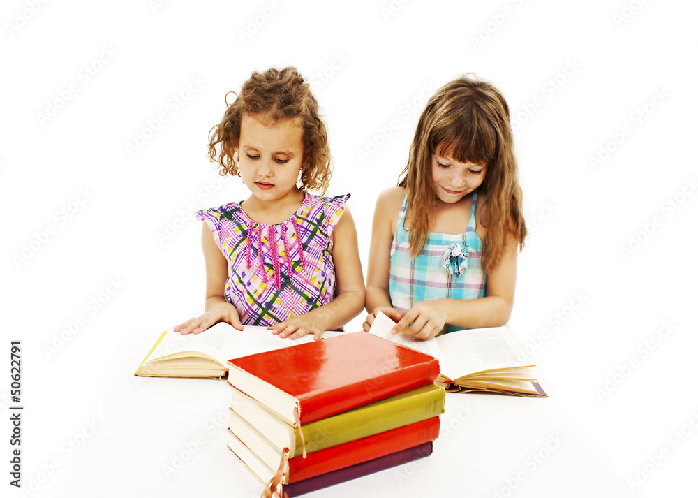 Portrait of two diligent girls at workplace on white background Portrait of two diligent girls at workplace on white background