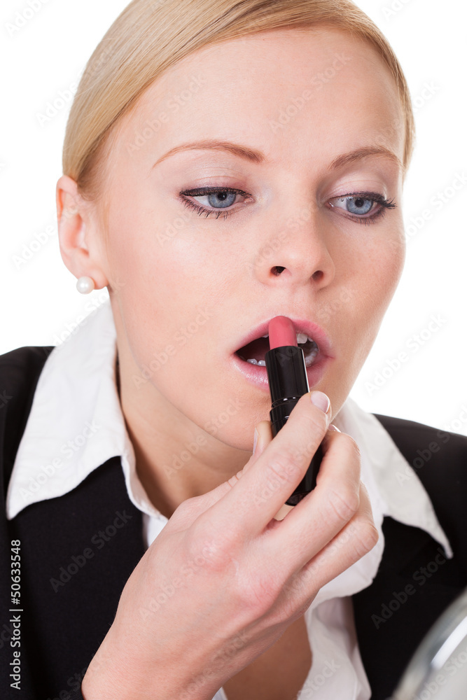 Attractive businesswoman applying lipstick Attractive businesswoman applying lipstick