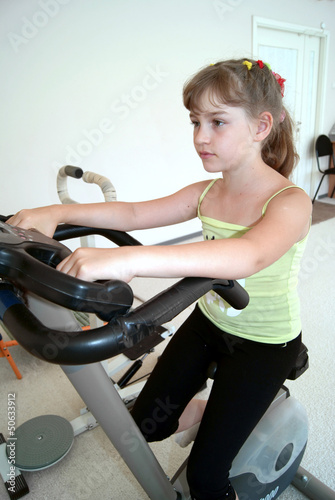 The girl is engaged on a velosimulator