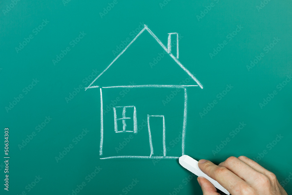 Drawing house on chalkboard