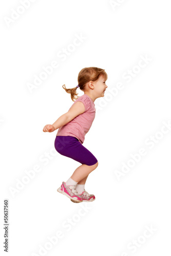 Little girl jumping. A side view.