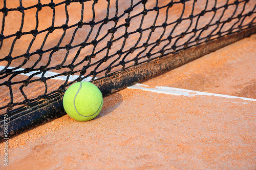 Tennis ball on a tennis clay court © tigger11th