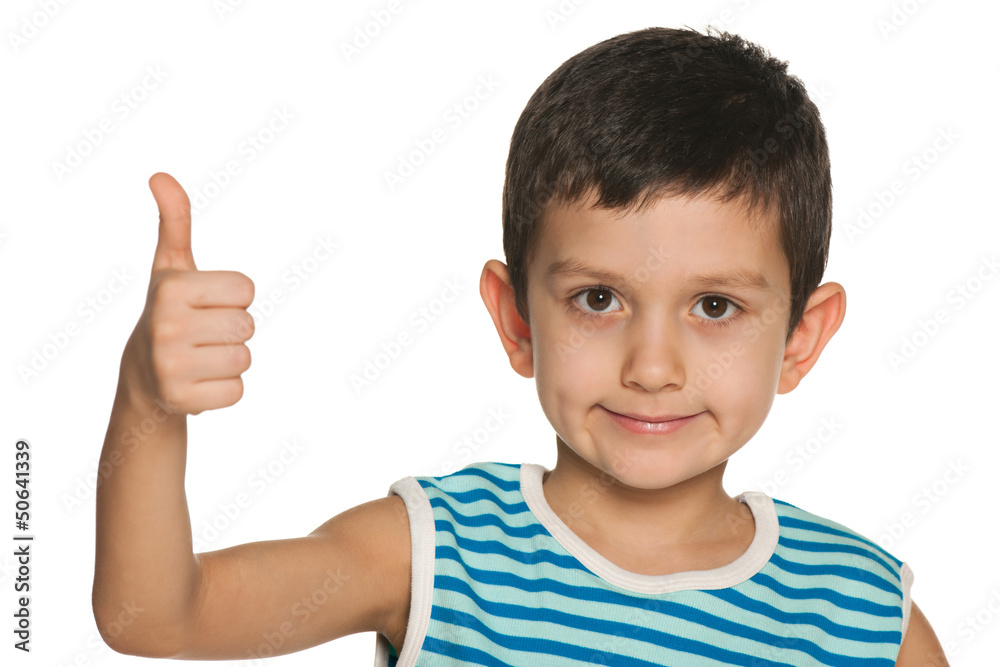 Closeup portrait of a boy holds his thumb up Closeup portrait of a boy holds his thumb up