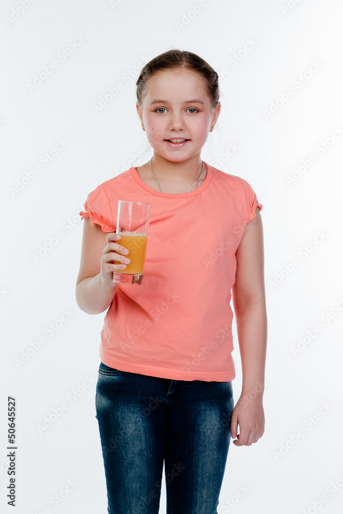 Small and beautiful girl with a glass of juice