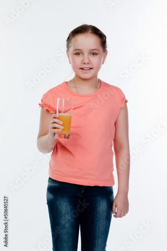 Small and beautiful girl with a glass of juice