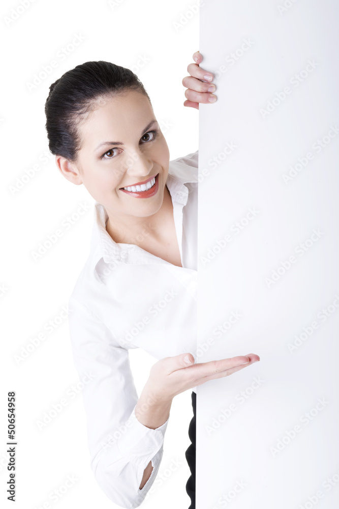 Smiling businesswoman showing blank signboard Smiling businesswoman showing blank signboard
