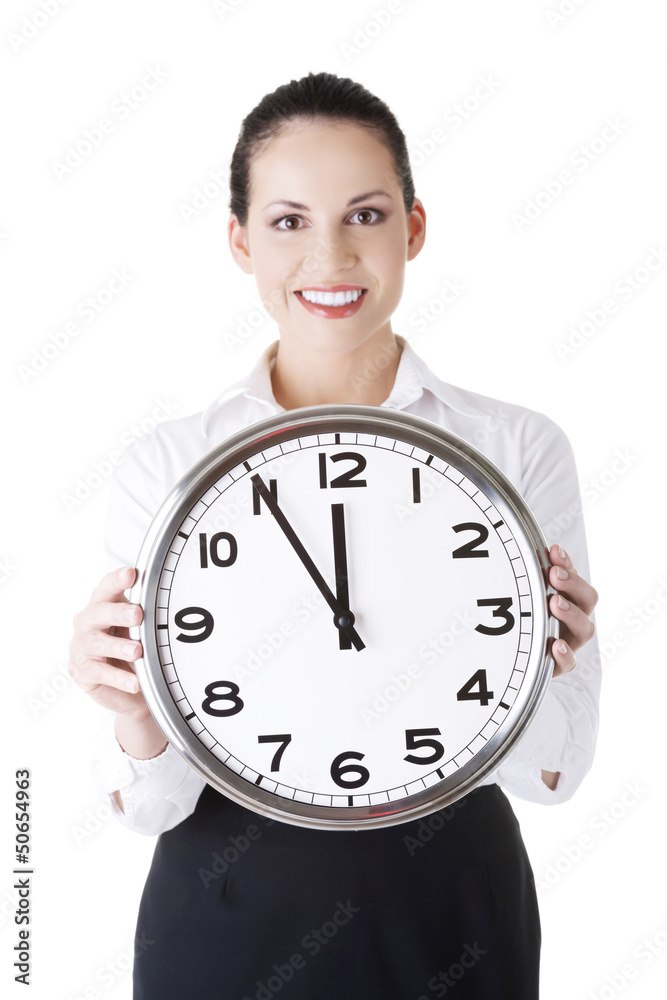 Happy young business woman holding office clock Happy young business woman holding office clock