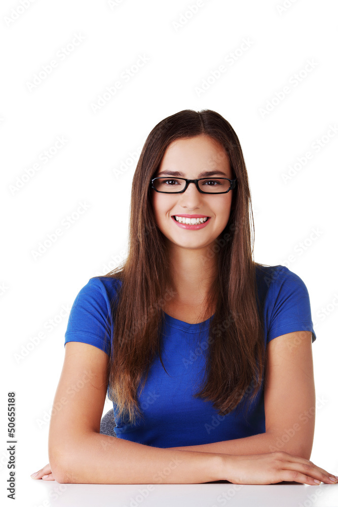 Smiling student girl sitting at the desk Smiling student girl sitting at the desk