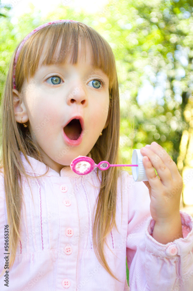 Little girl blowing soap bubbles Little girl blowing soap bubbles
