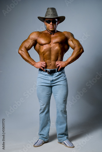 Muscular male in a hat and sunglasses