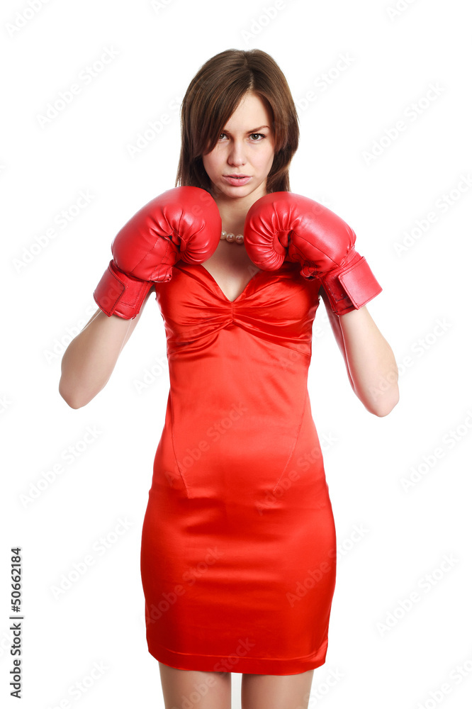 Woman in red, wearing boxing gloves, isolated on white