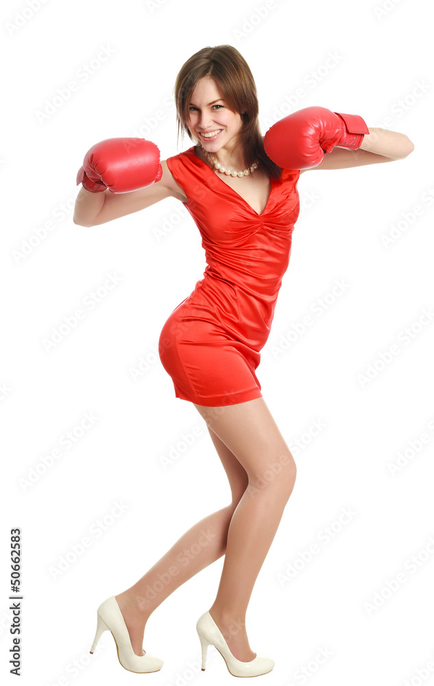 Woman in red, wearing boxing gloves, isolated on white