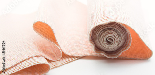 Roll of medical elastic bandage in white background
