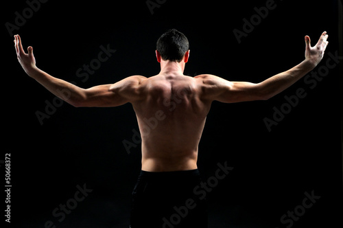 handsome muscleman against dark background