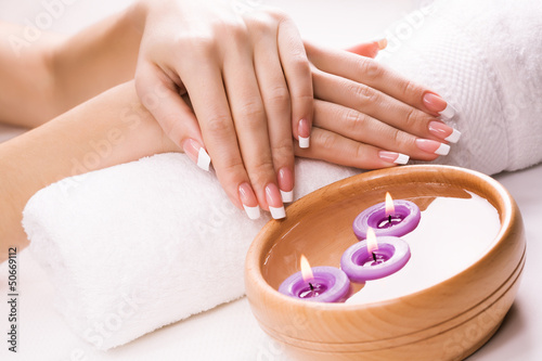 french manicure with aromatic candles and towel. Spa