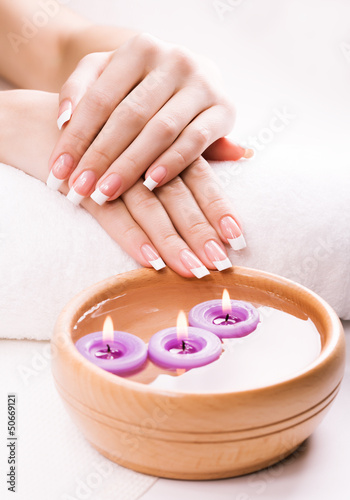 french manicure with aromatic candles and towel. Spa