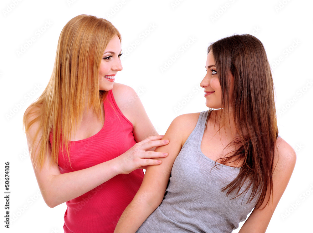Two girl friends hugging isolated on white Two girl friends hugging isolated on white