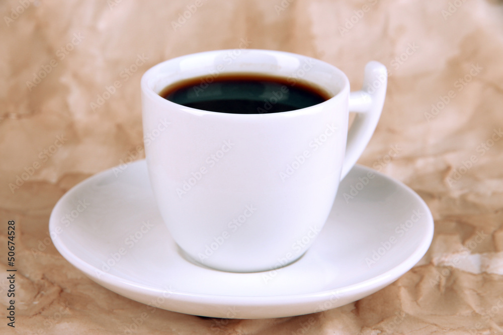 Cup of strong coffee on beige background