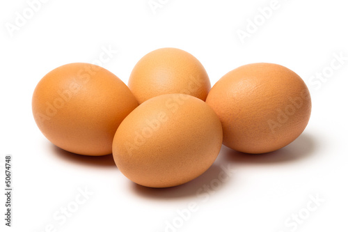 Four eggs with shadows isolated on white background