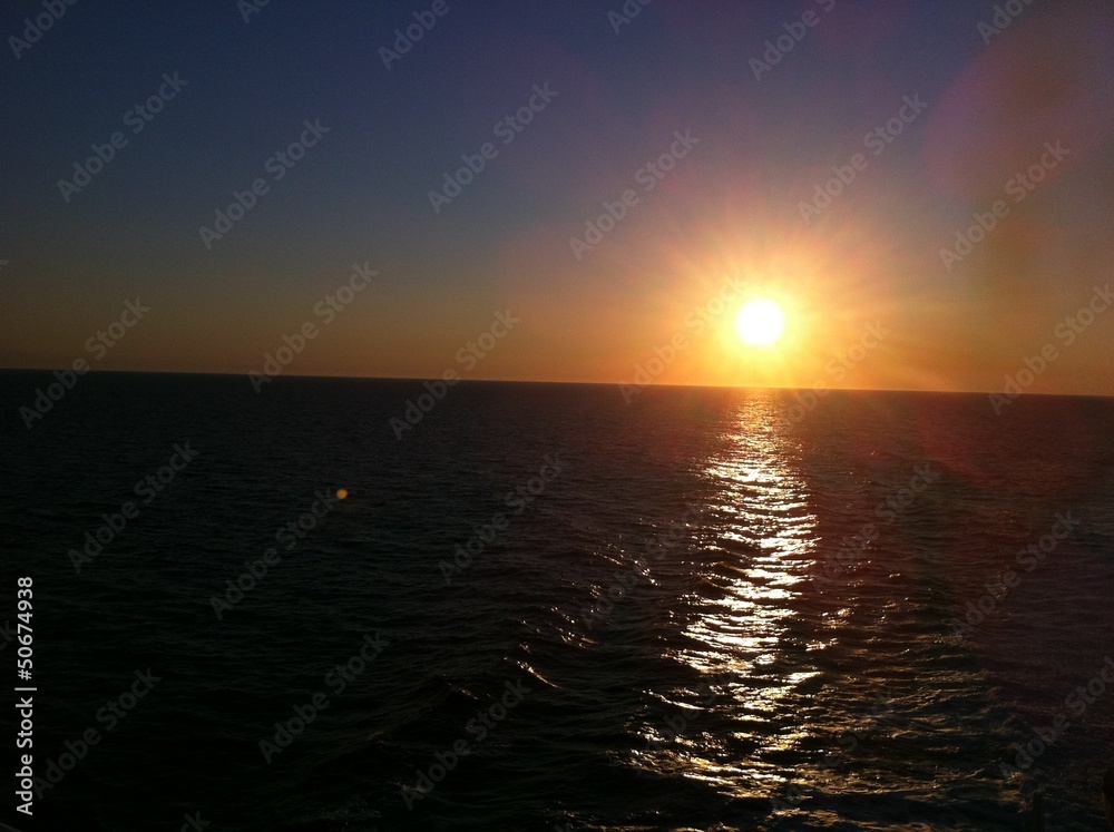 Fototapeta premium coucher du soleil au milieu de la mer