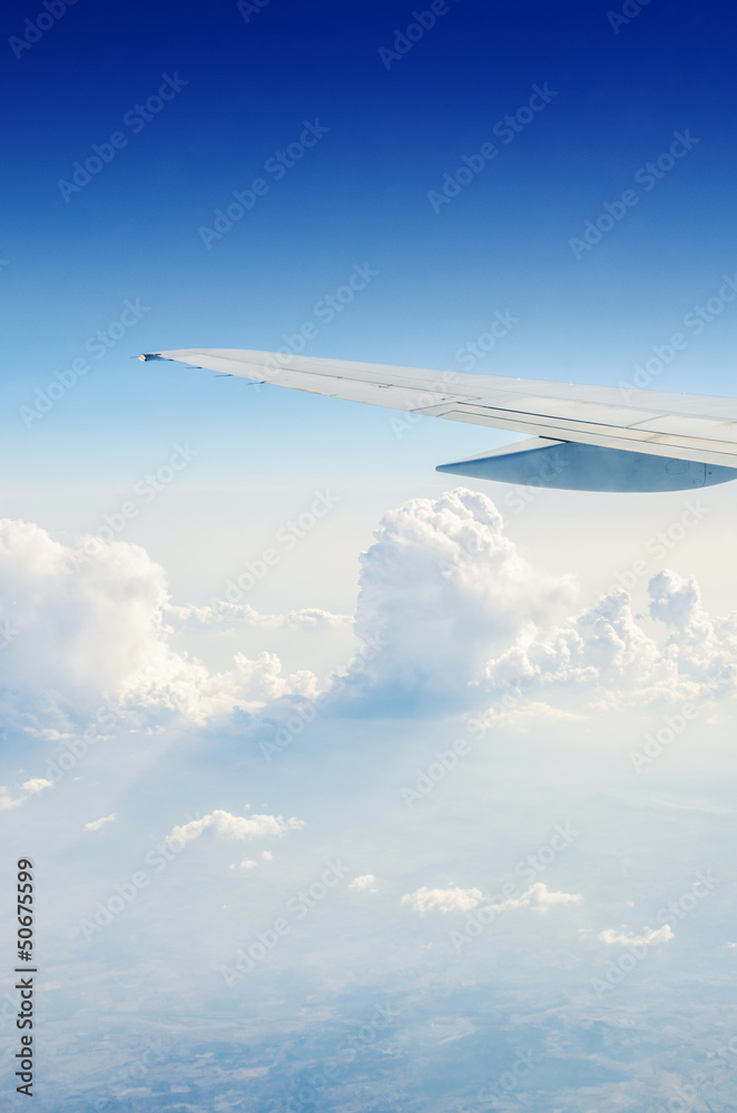Obraz premium Airplane wing out of window