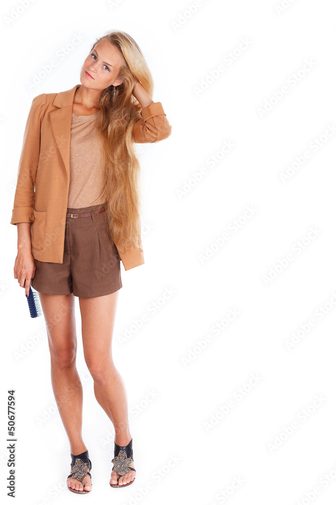 Attractive fit blondie is holding hairbrush and touching her hai Attractive fit blondie is holding hairbrush and touching her hai