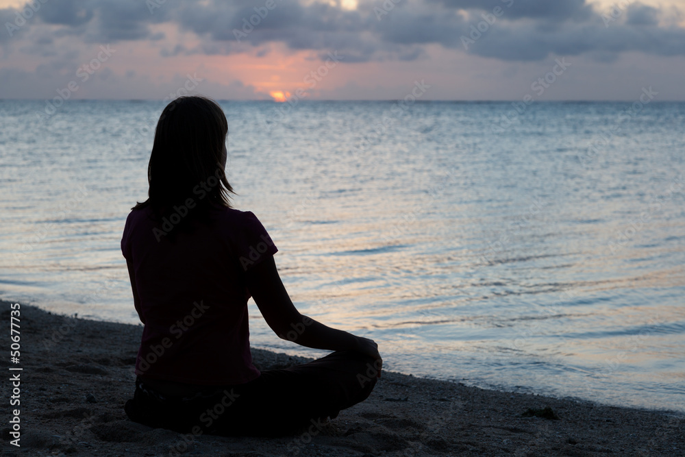 Fototapeta premium woman meditation on the beach