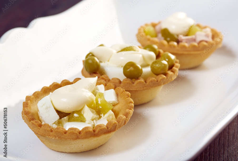 tartlet with salad on a white plate tartlet with salad on a white plate