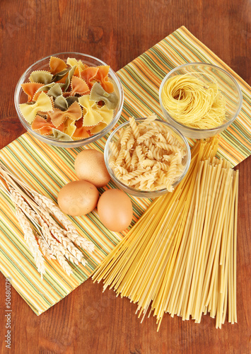 Different types of pasta on striped tablecloth