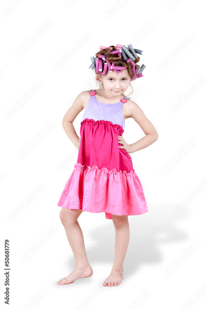 Little girl with hair-curlers in her hair poses with her hands Little girl with hair-curlers in her hair poses with her hands
