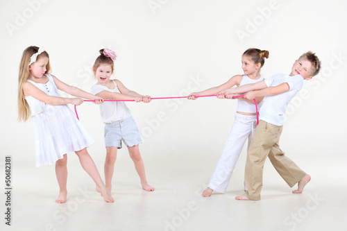 Four cute little boys and girls overtighten pink rope