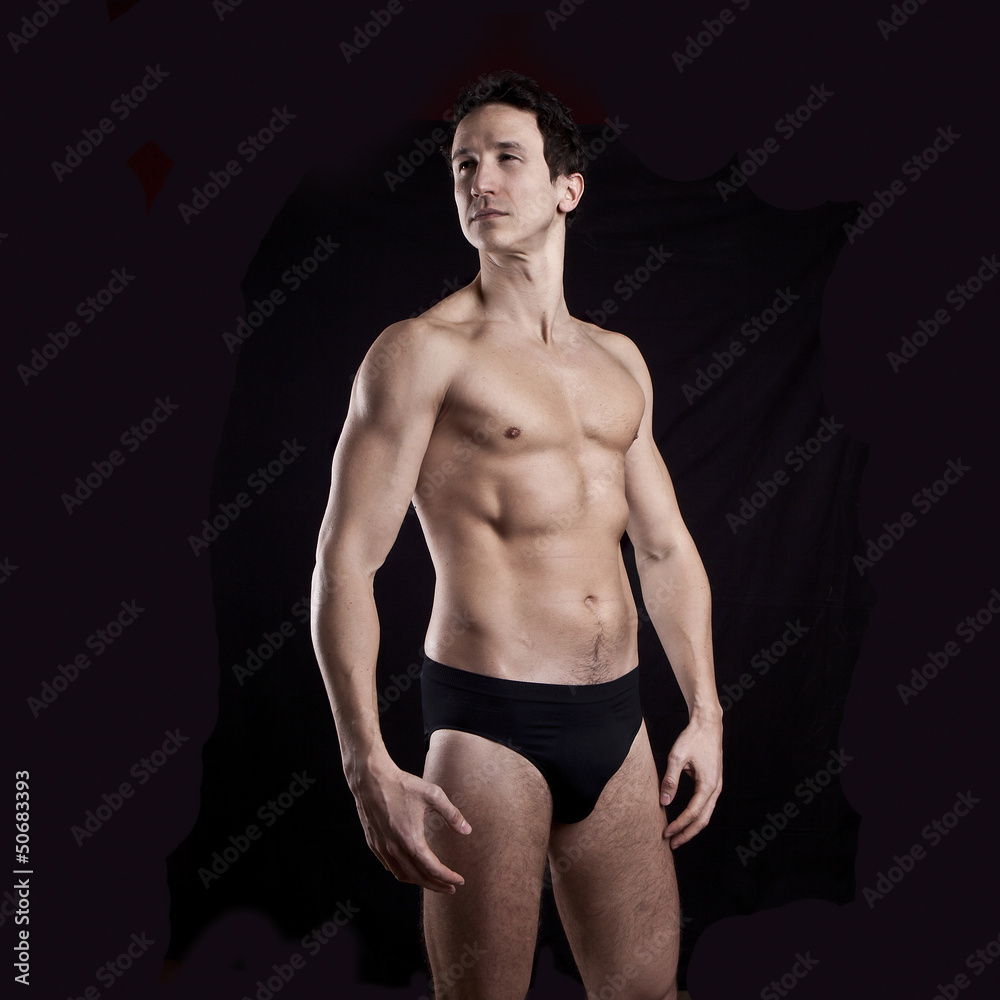 Handsome muscular guy  on black background