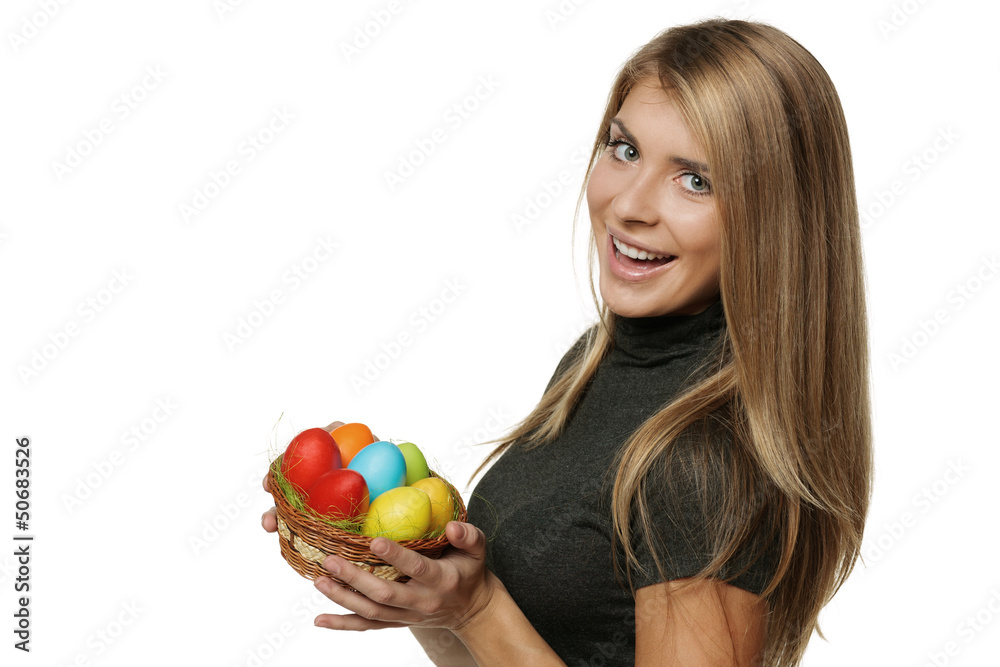 Smiling woman holding basket with Easter eggs Smiling woman holding basket with Easter eggs