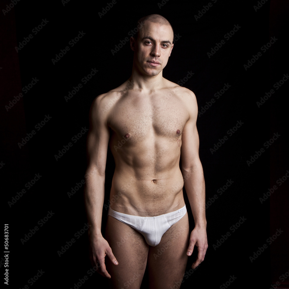 Handsome muscular guy in underwear on black background Handsome muscular guy in underwear on black background
