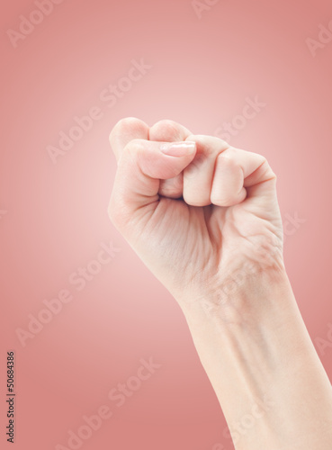 Fist. Gesture of the hand on pink background.