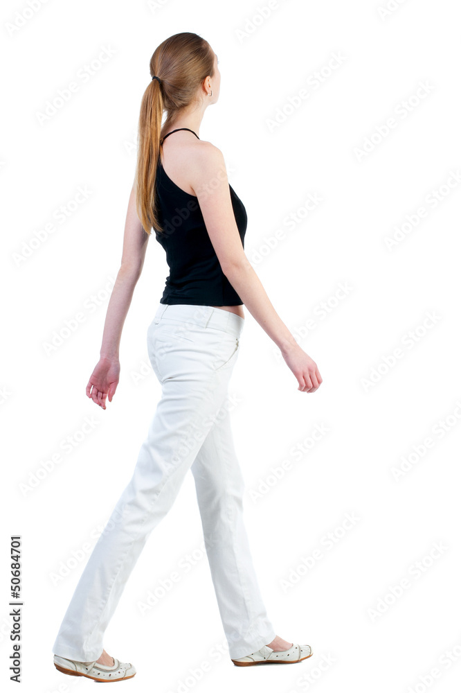back view of walking woman back view of walking woman