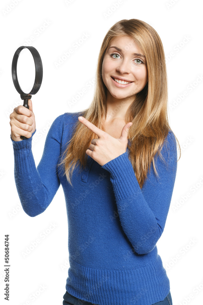 Happy female holding magnifying glass and pointing at it Happy female holding magnifying glass and pointing at it