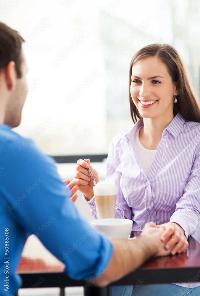 Couple sitting in cafe drinking coffee