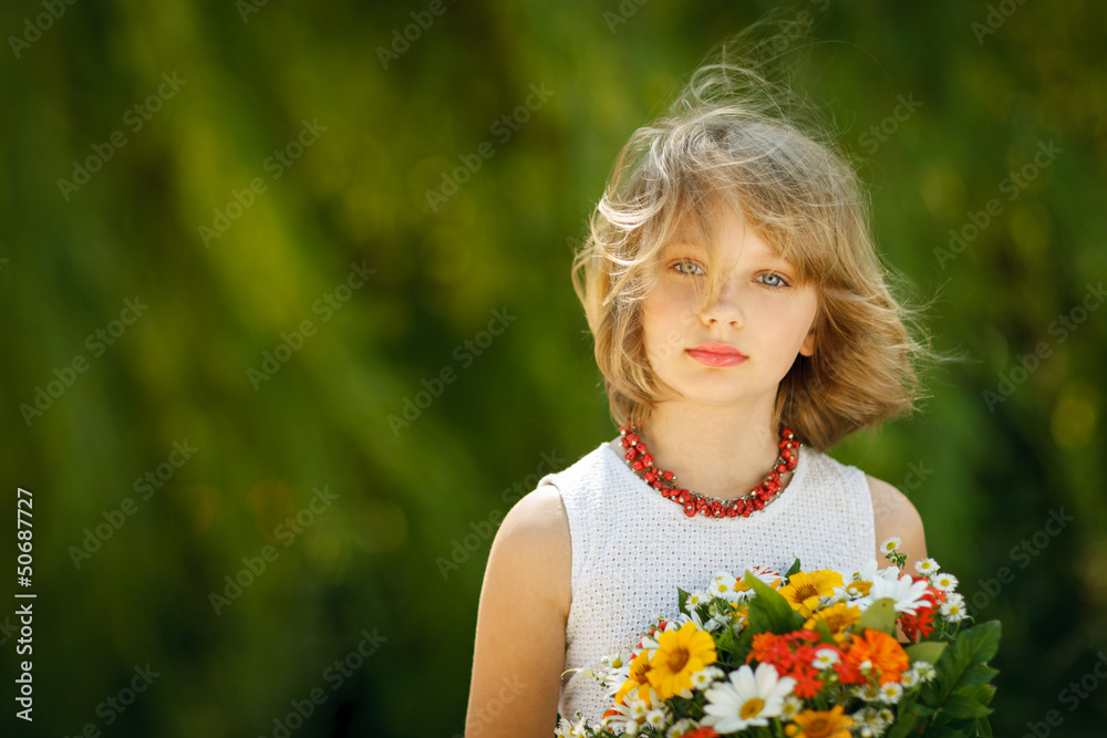 Girl with bunch of flowers standing outdoors Girl with bunch of flowers standing outdoors