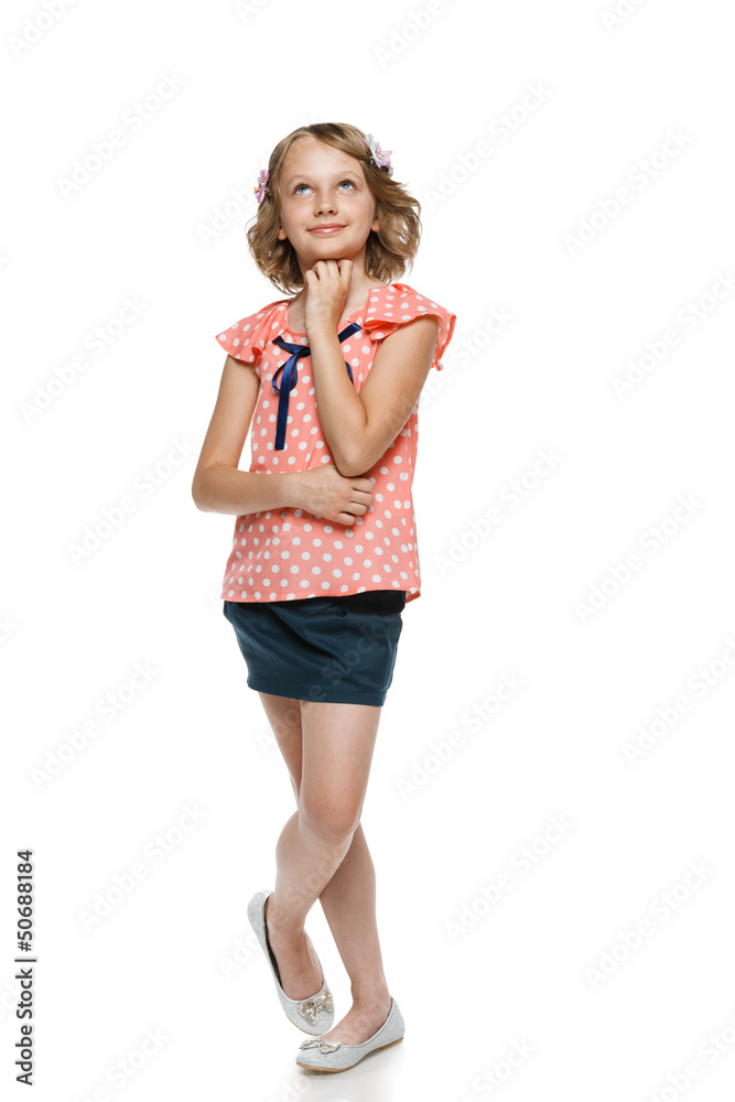 Smiling little girl in full length looking up Smiling little girl in full length looking up