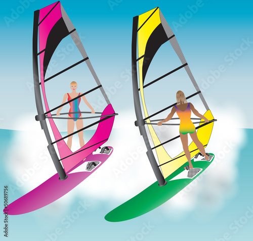 Two Pretty Women Windsurfing down a wave