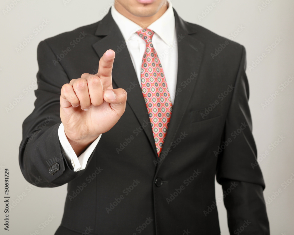 A businessman showing something isolated on white background A businessman showing something isolated on white background
