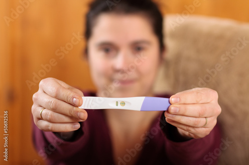 Woman holding a pregnancy test