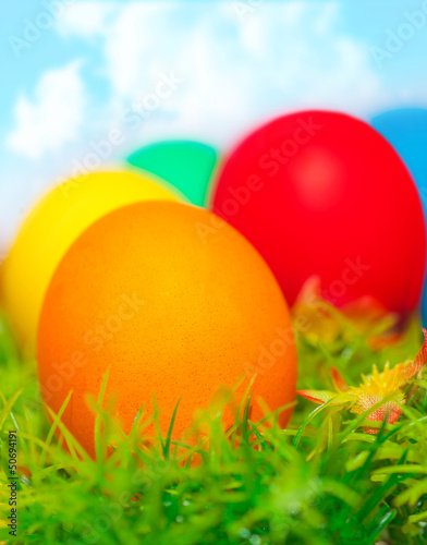 Colorful eggs on green grass