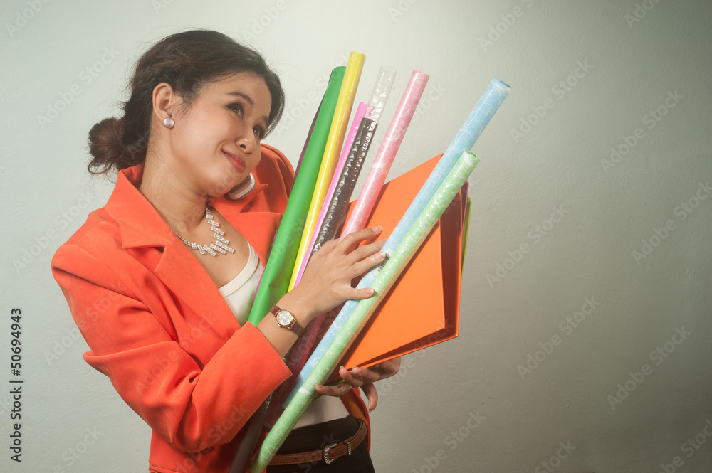 Busy Asian business woman with a folders and colorful papers. Busy Asian business woman with a folders and colorful papers.