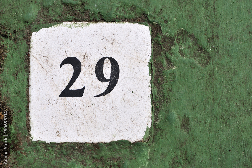 white tile with the number 29 on a green background painted ceme white tile with the number 29 on a green background painted ceme