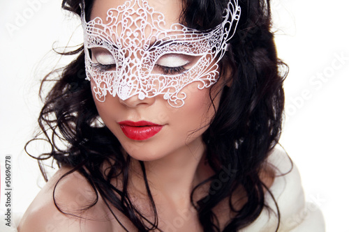 Portrait of beautiful girl in Carnival mask on face isolated on