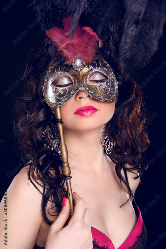 Masquerade. Sexy woman with Carnival mask on face