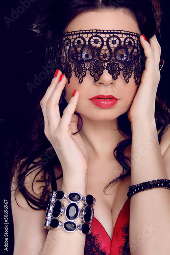 Sexy beautiful woman with black lace pattern on eyes and red lip
